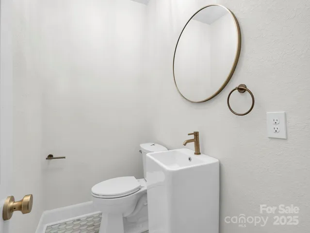 a view of empty room with wooden floor and window