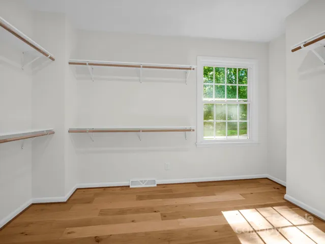 a spacious bathroom with a double vanity sink a mirror and a