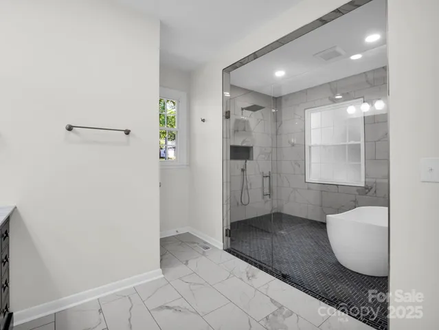 a bathroom with a bathtub and window
