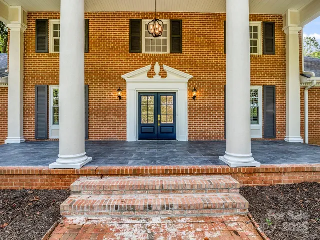 a view of a brick house with large windows