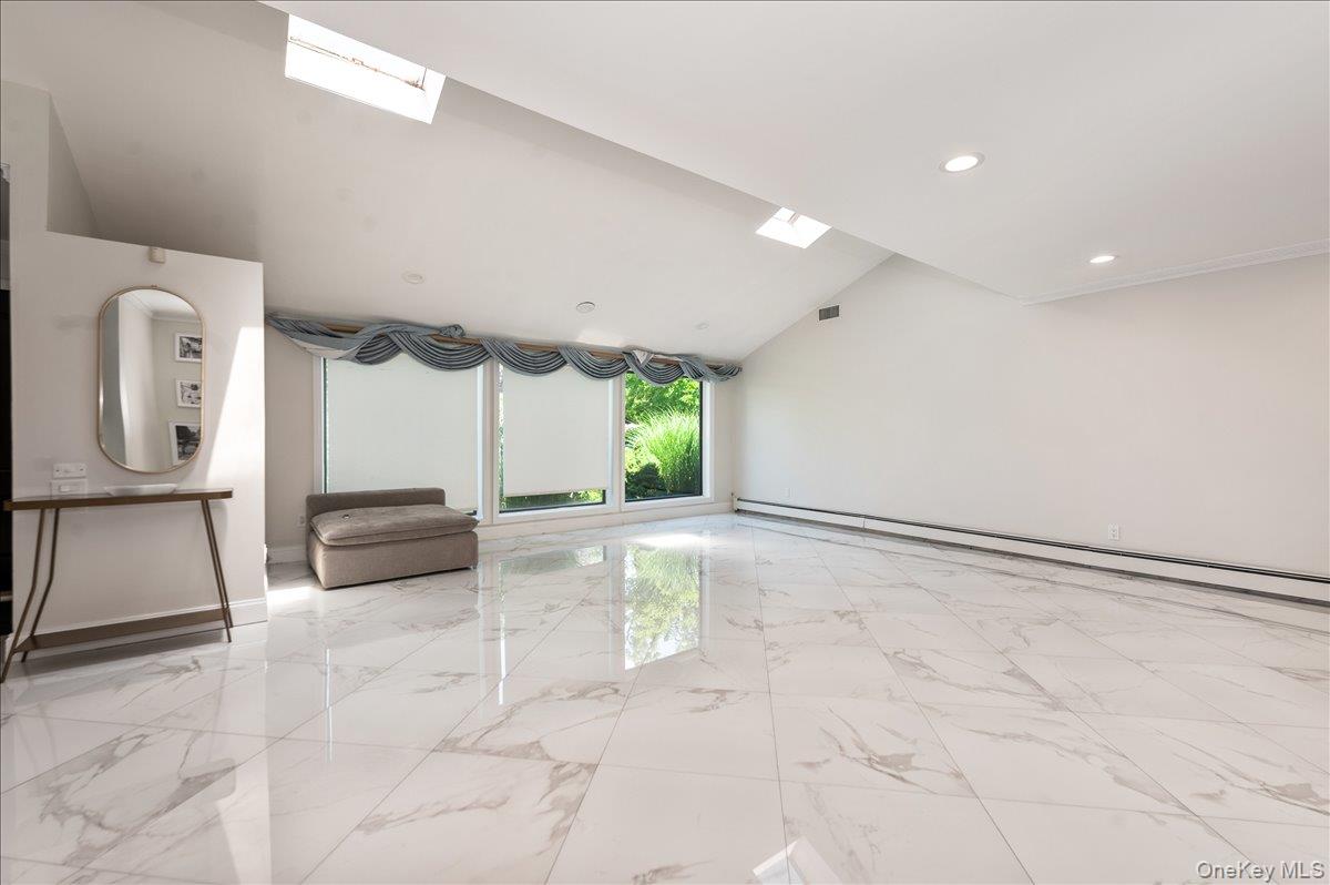 70 Longfellow Road Great Neck, NY 11023 - Photo 2 of 28 a view of a hallway with a couch and chandelier