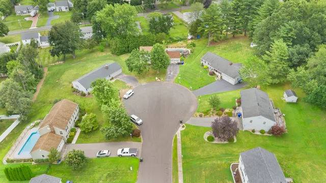 an aerial view of a house with a yard basket ball court and outdoor seating