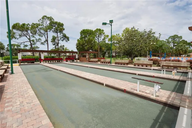a view of a patio with table and chairs with wooden floor and fence