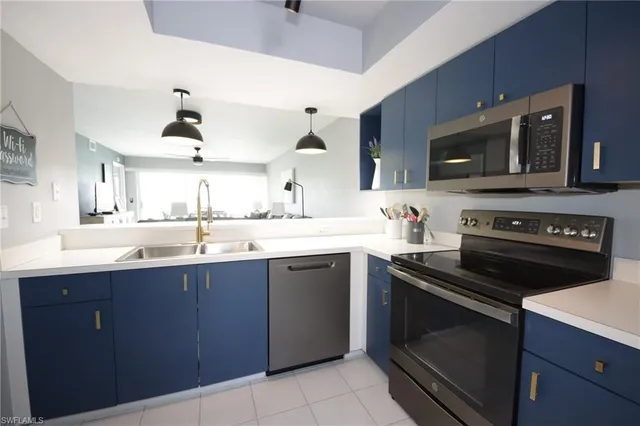a kitchen with a sink stove and microwave