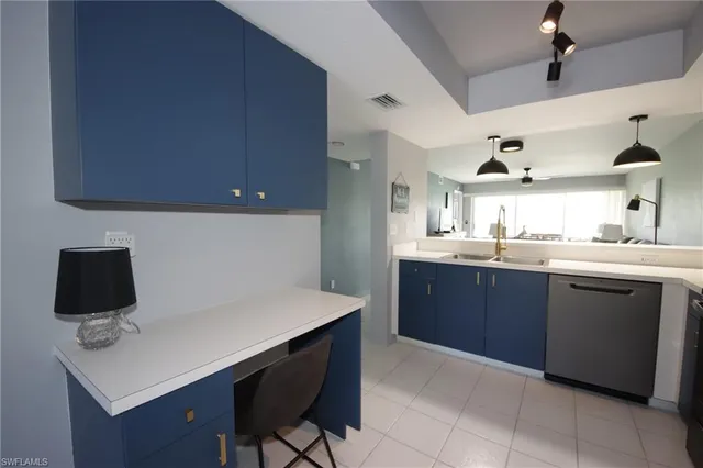 a kitchen with a sink cabinets and appliances