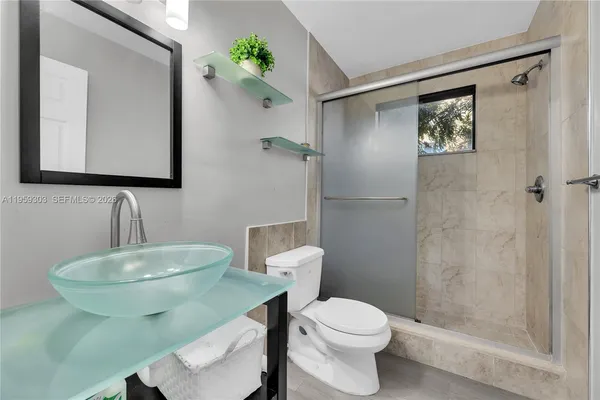 a bathroom with a toilet a sink and mirror