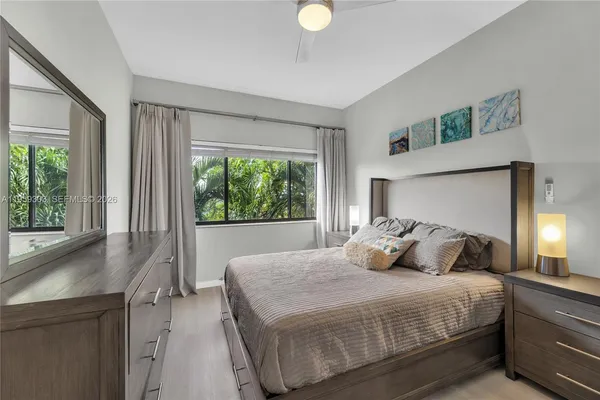 a bedroom with a large bed and a large window