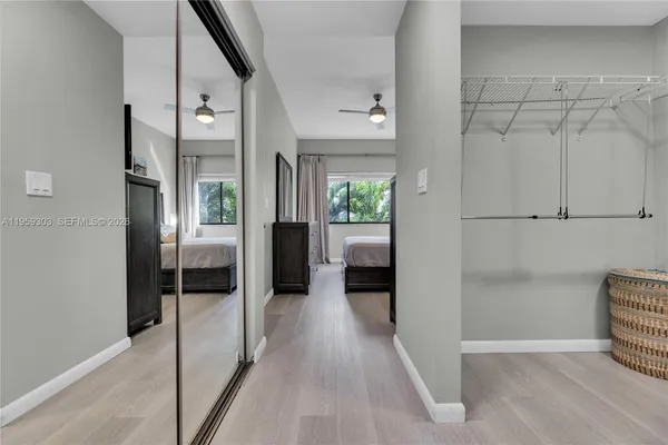 a view of a hallway with wooden floor and a living room