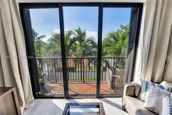 a view of a balcony with chair and floor to ceiling window