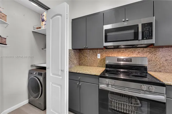 a kitchen with a stove and a microwave