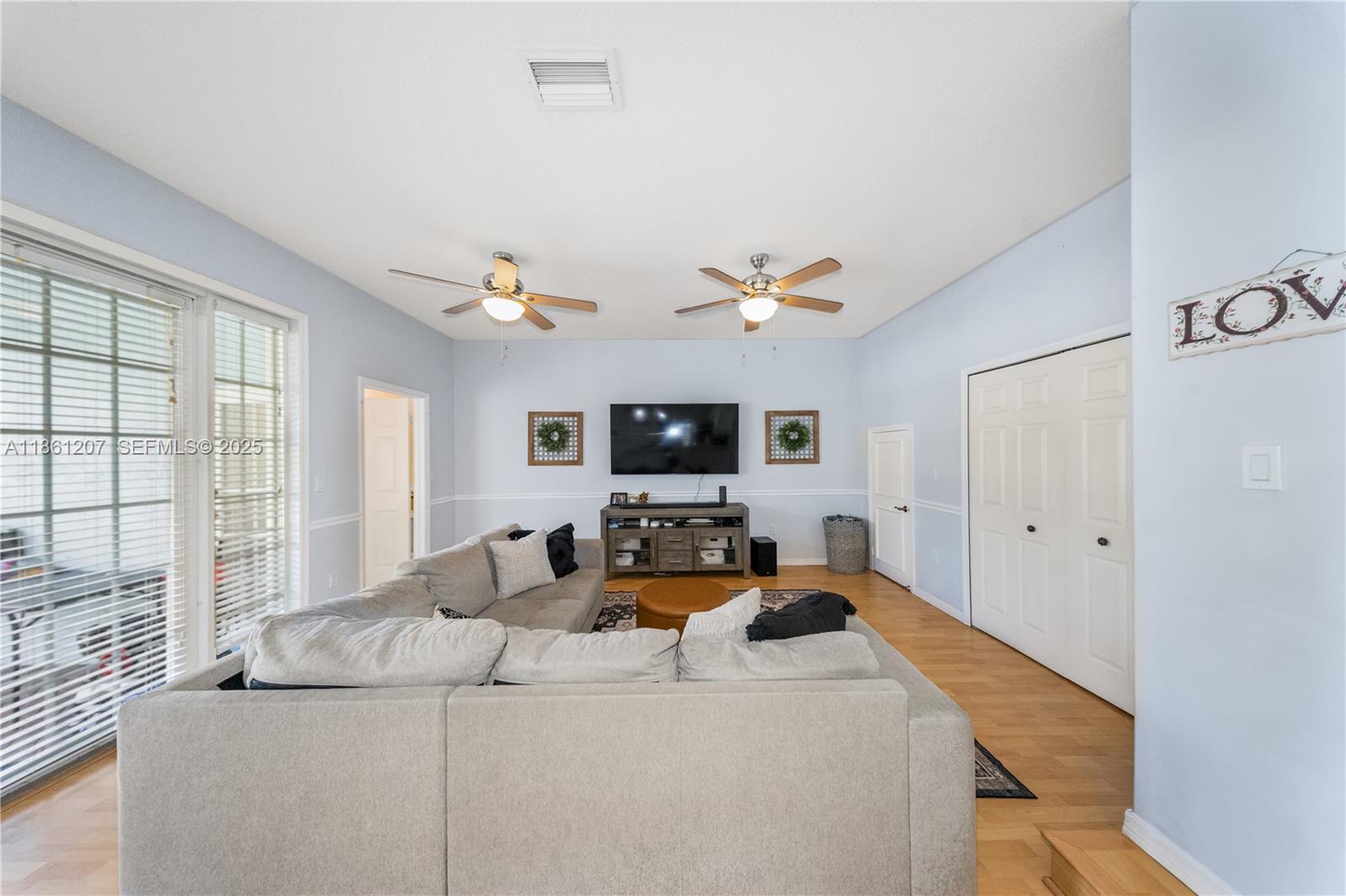 9822 Southwest 161st Place Miami, FL 33196 - Photo 13 of 47 a living room with furniture and flat screen tv