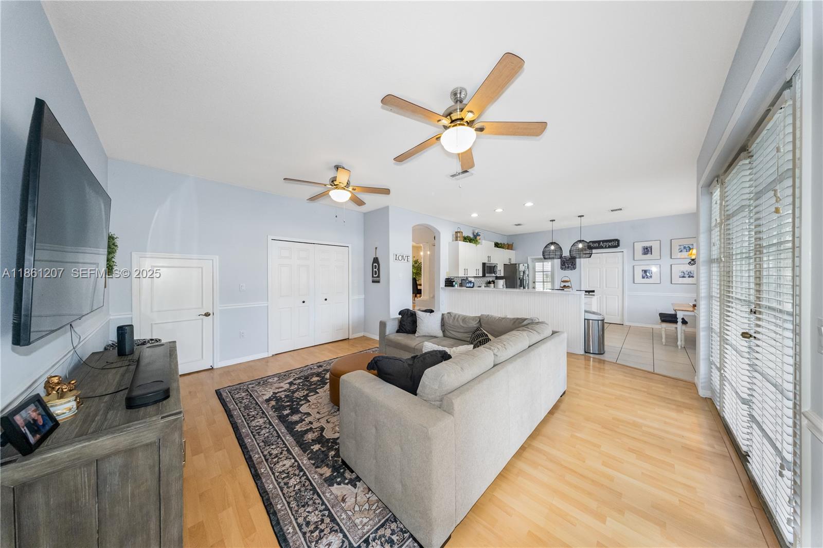 9822 Southwest 161st Place Miami, FL 33196 - Photo 14 of 47 a living room with furniture and a flat screen tv