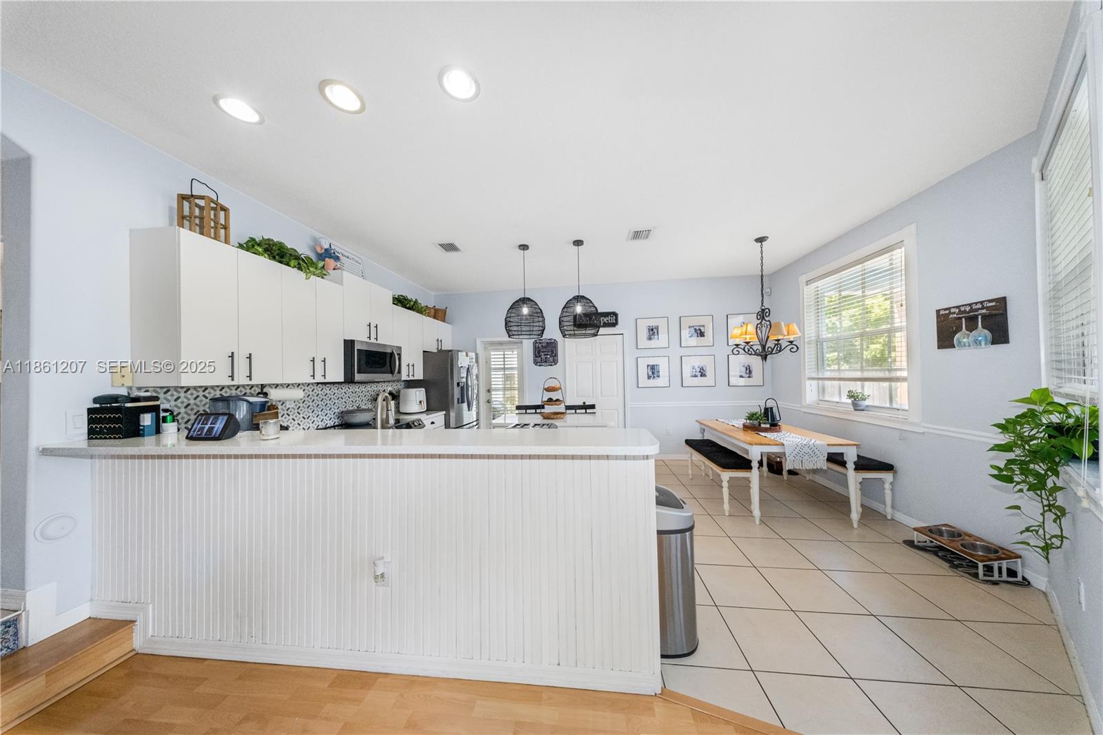 9822 Southwest 161st Place Miami, FL 33196 - Photo 16 of 47 a kitchen with stainless steel appliances granite countertop a sink and cabinets