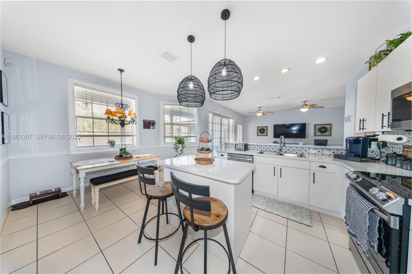 9822 Southwest 161st Place Miami, FL 33196 - Photo 19 of 47 a kitchen with sink cabinets and stainless steel appliances