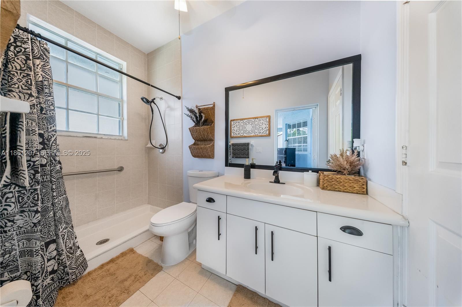 9822 Southwest 161st Place Miami, FL 33196 - Photo 23 of 47 a bathroom with a sink a toilet and shower