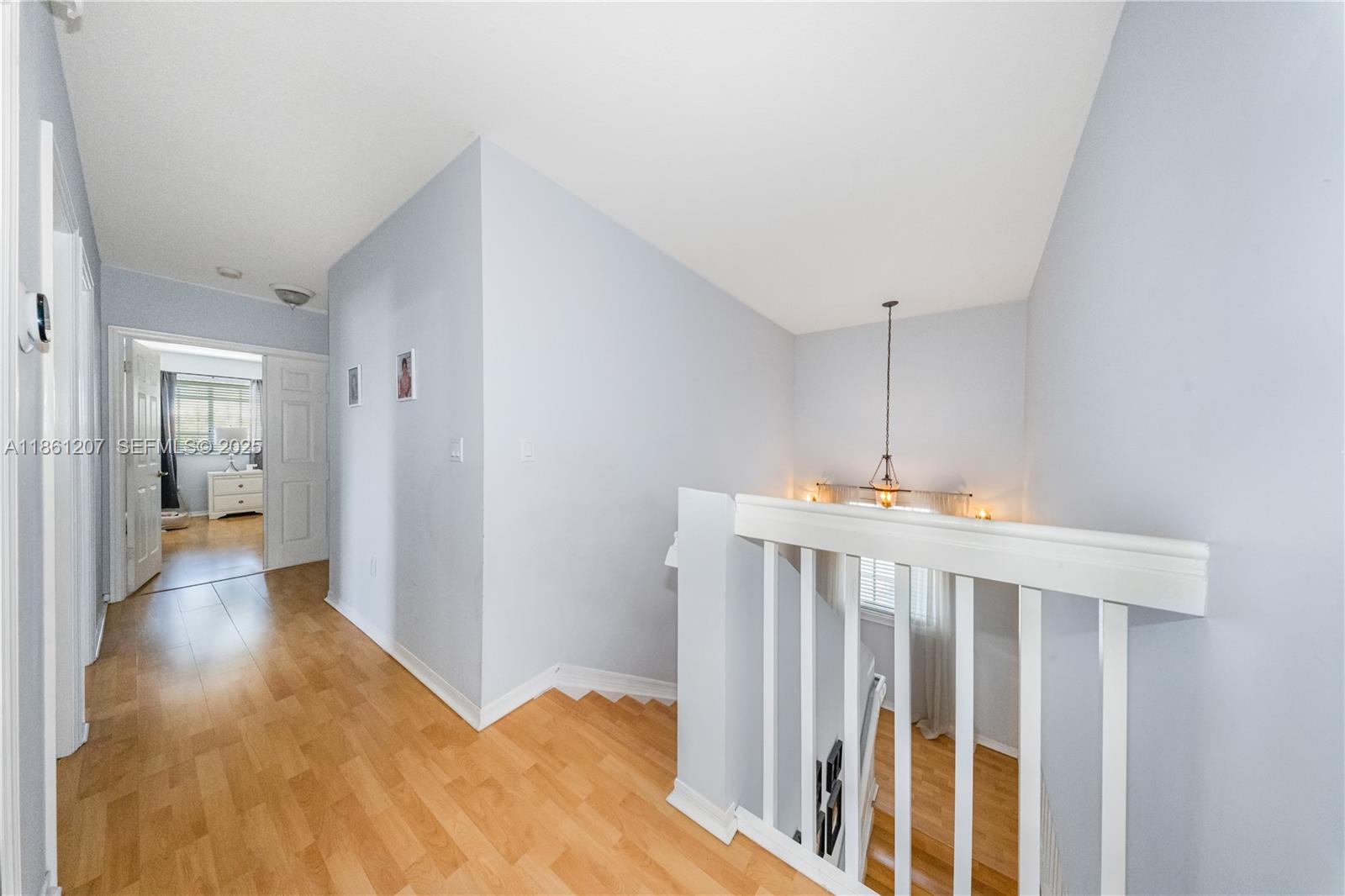 9822 Southwest 161st Place Miami, FL 33196 - Photo 24 of 47 a view of a hallway with wooden floor
