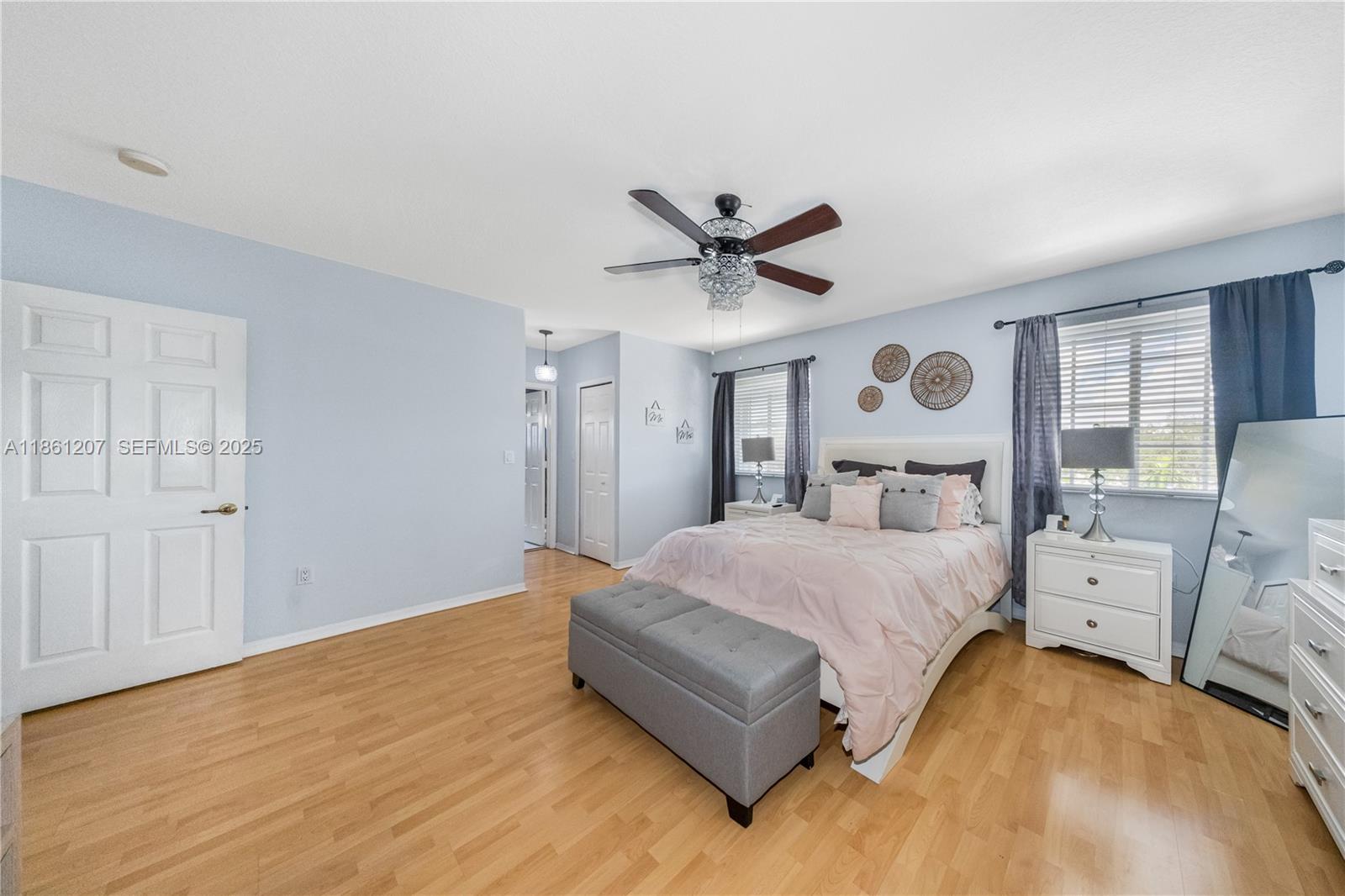 9822 Southwest 161st Place Miami, FL 33196 - Photo 25 of 47 a spacious bedroom with a bed and window