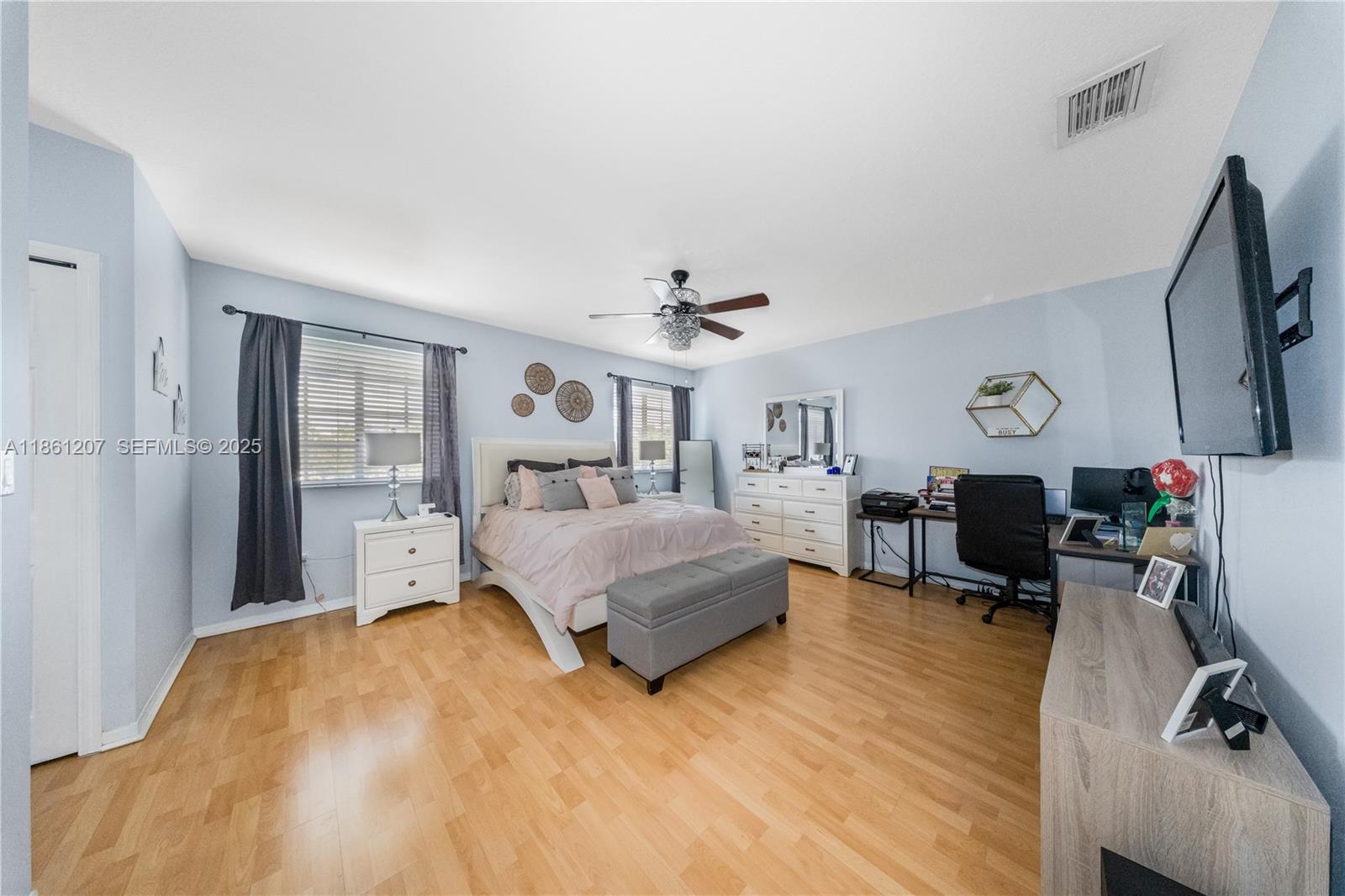 9822 Southwest 161st Place Miami, FL 33196 - Photo 26 of 47 a bedroom with a bed window table chair and a dresser in it