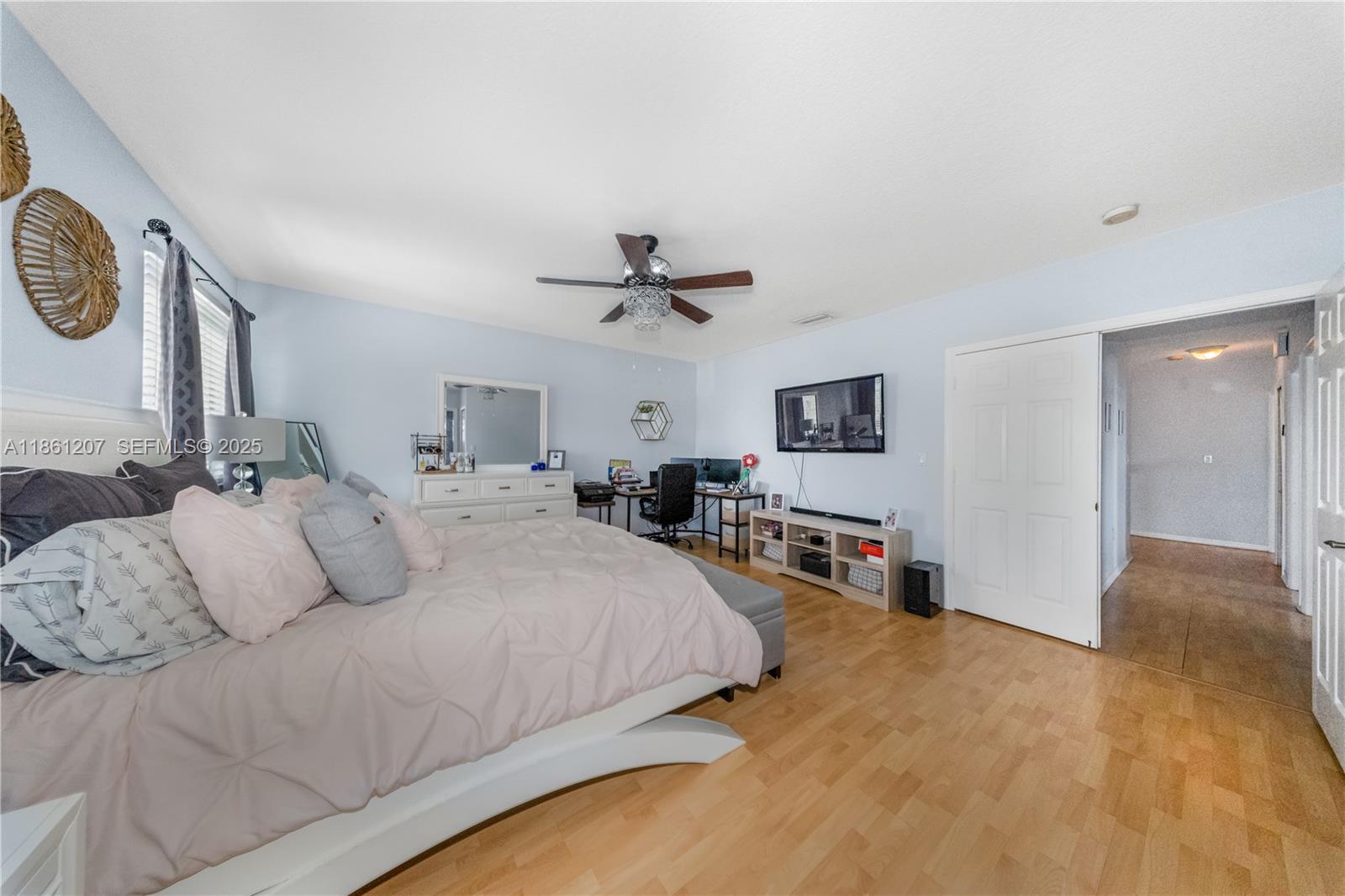 9822 Southwest 161st Place Miami, FL 33196 - Photo 27 of 47 a bedroom with a large bed and a tv