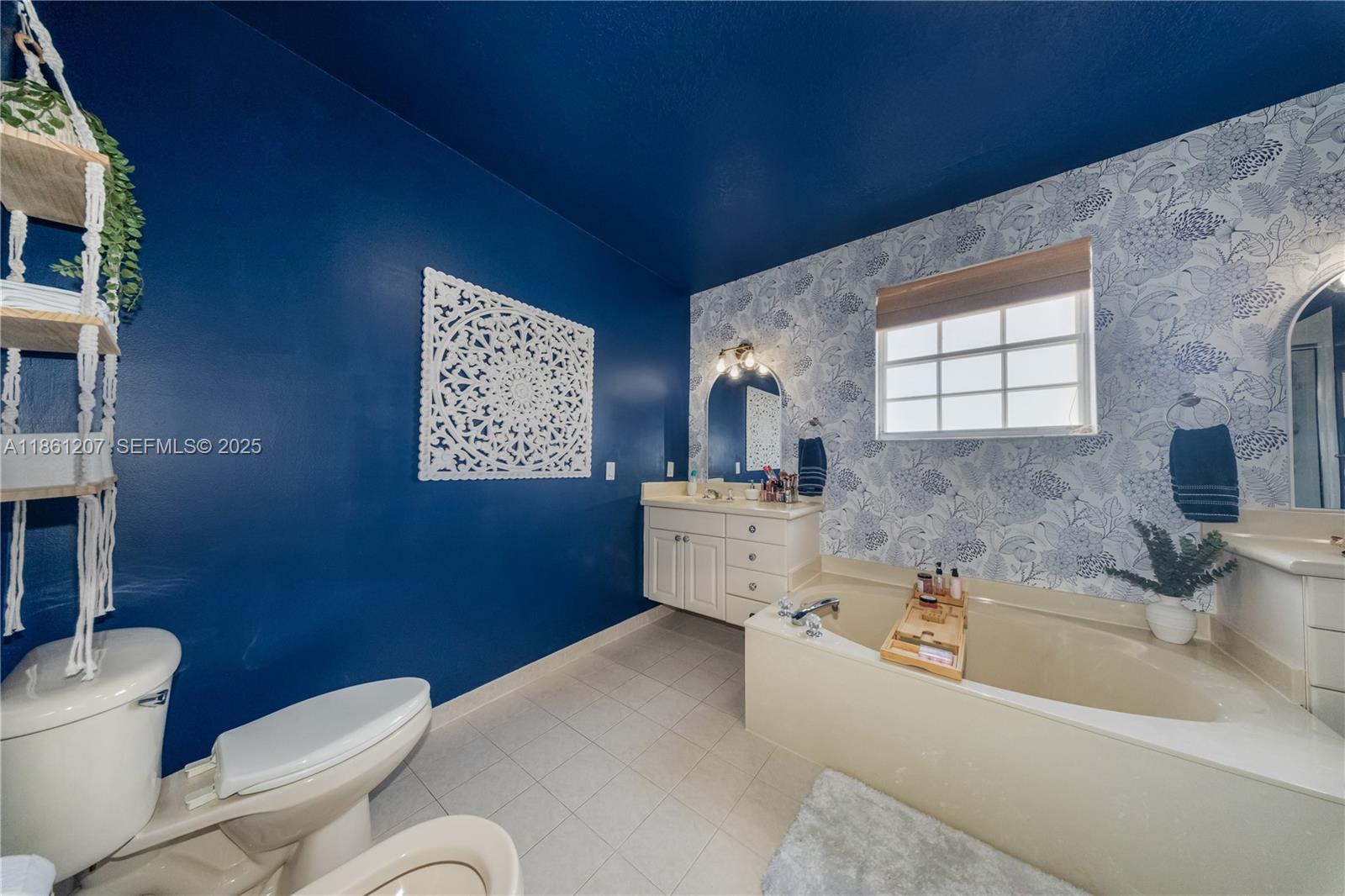 9822 Southwest 161st Place Miami, FL 33196 - Photo 28 of 47 a bathroom with a toilet sink and mirror