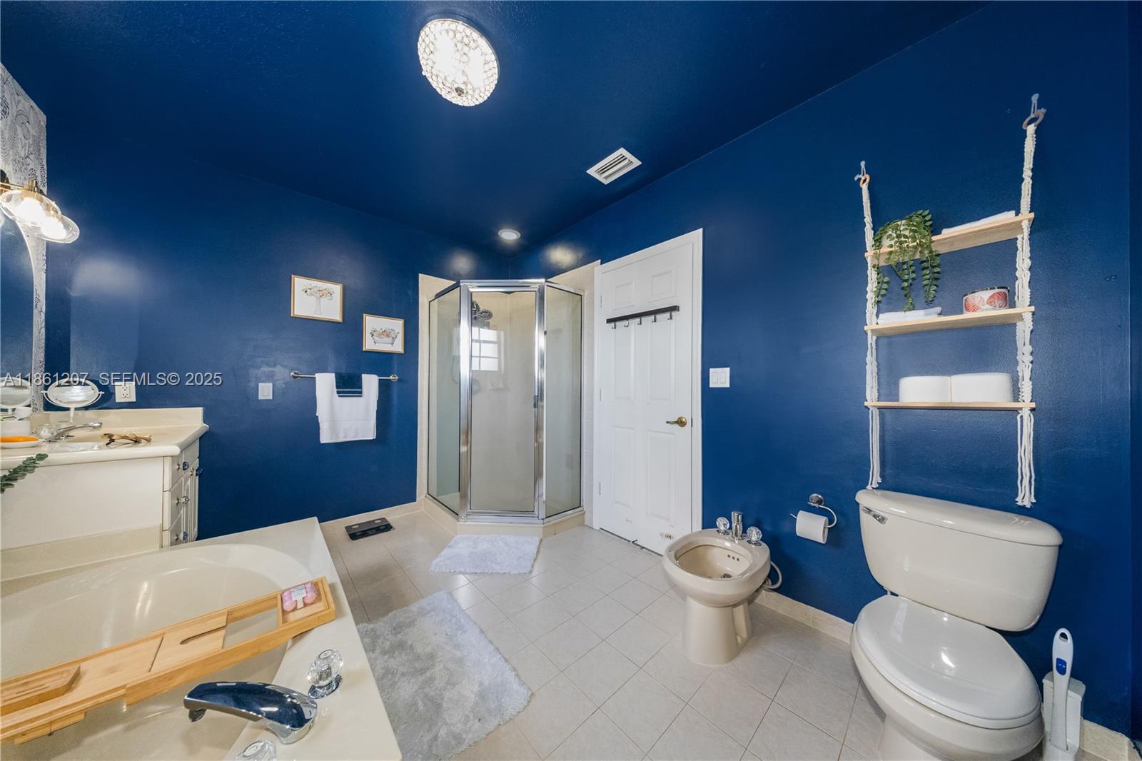 9822 Southwest 161st Place Miami, FL 33196 - Photo 30 of 47 a bathroom with a toilet sink and mirror