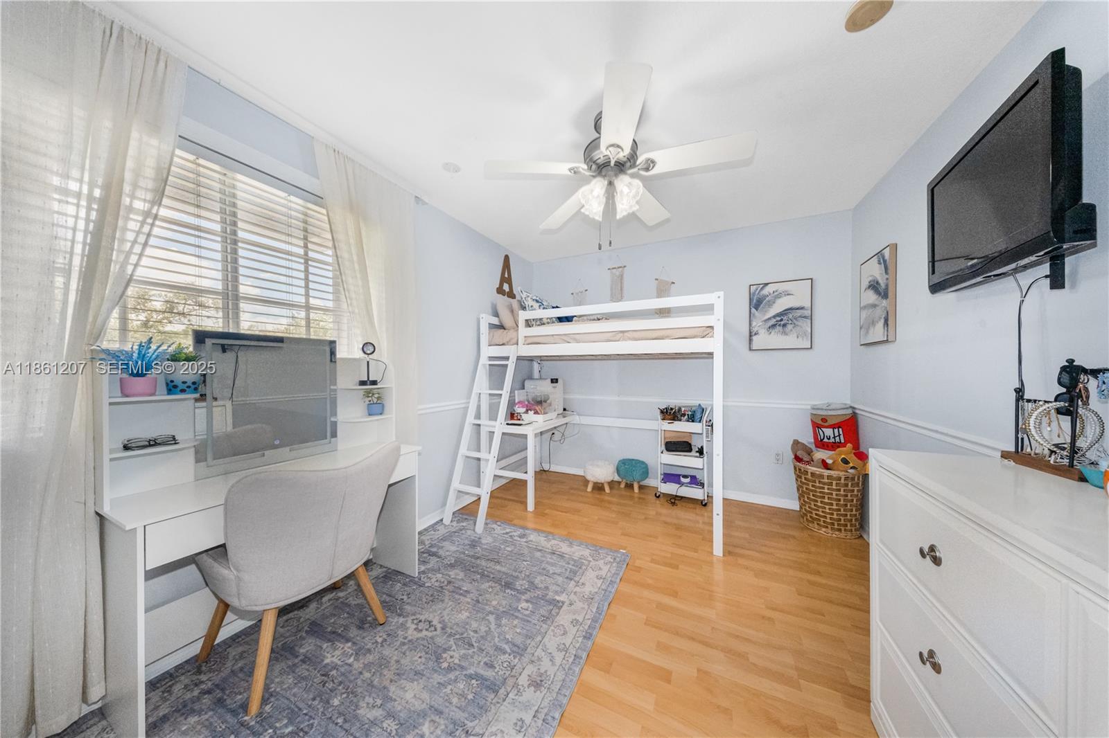 9822 Southwest 161st Place Miami, FL 33196 - Photo 31 of 47 a living room with furniture and a flat screen tv