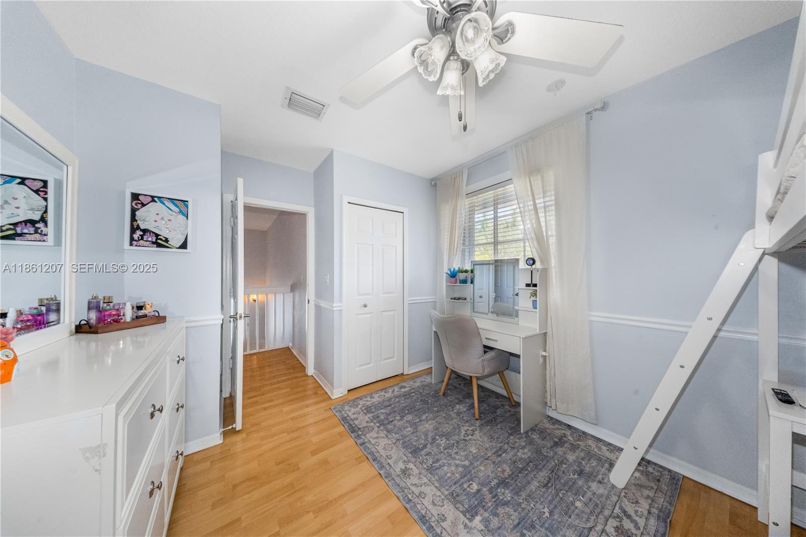 9822 Southwest 161st Place Miami, FL 33196 - Photo 32 of 47 a living room with a baby crib furniture and a chandelier