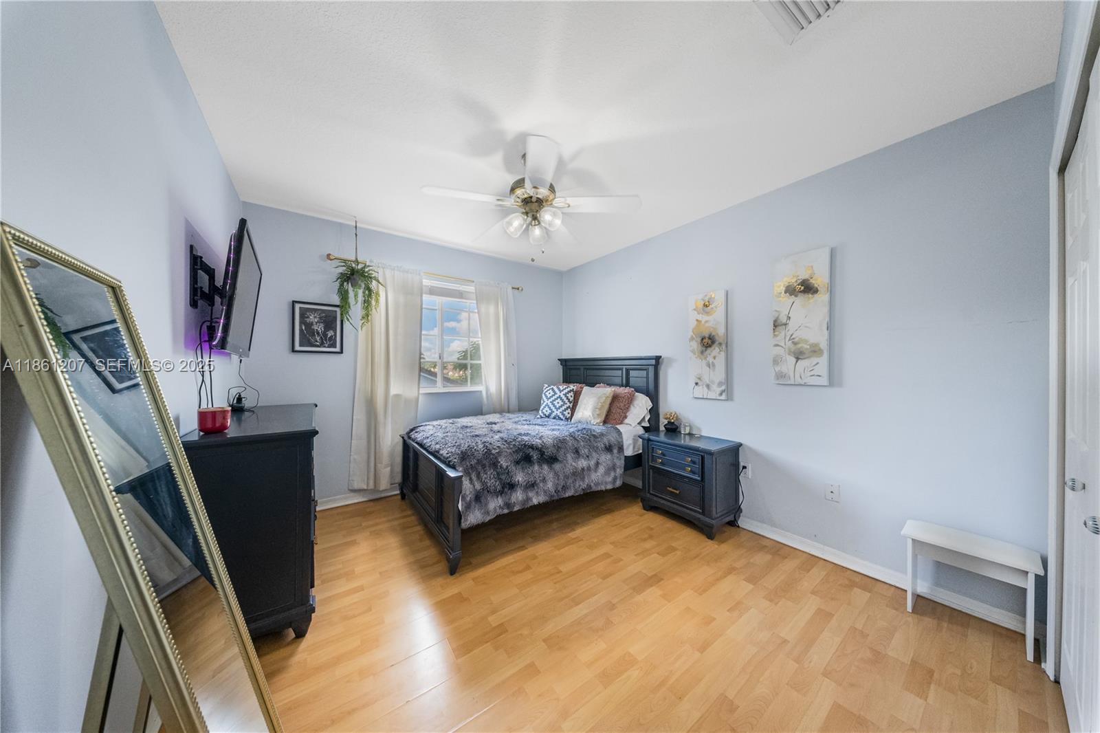 9822 Southwest 161st Place Miami, FL 33196 - Photo 34 of 47 a bedroom with a bed dresser and a window