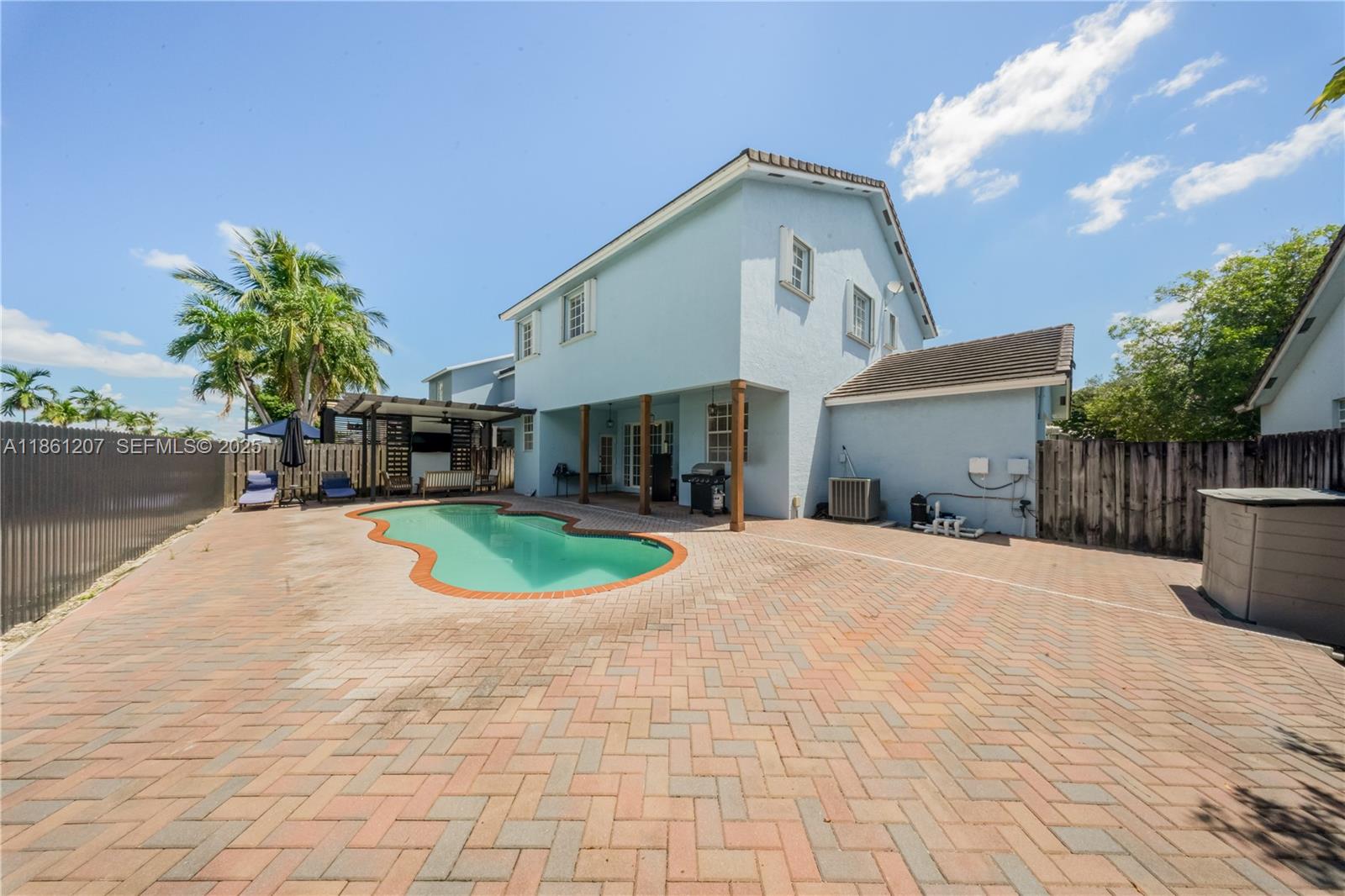 9822 Southwest 161st Place Miami, FL 33196 - Photo 40 of 47 a front view of a house with a yard and potted plants