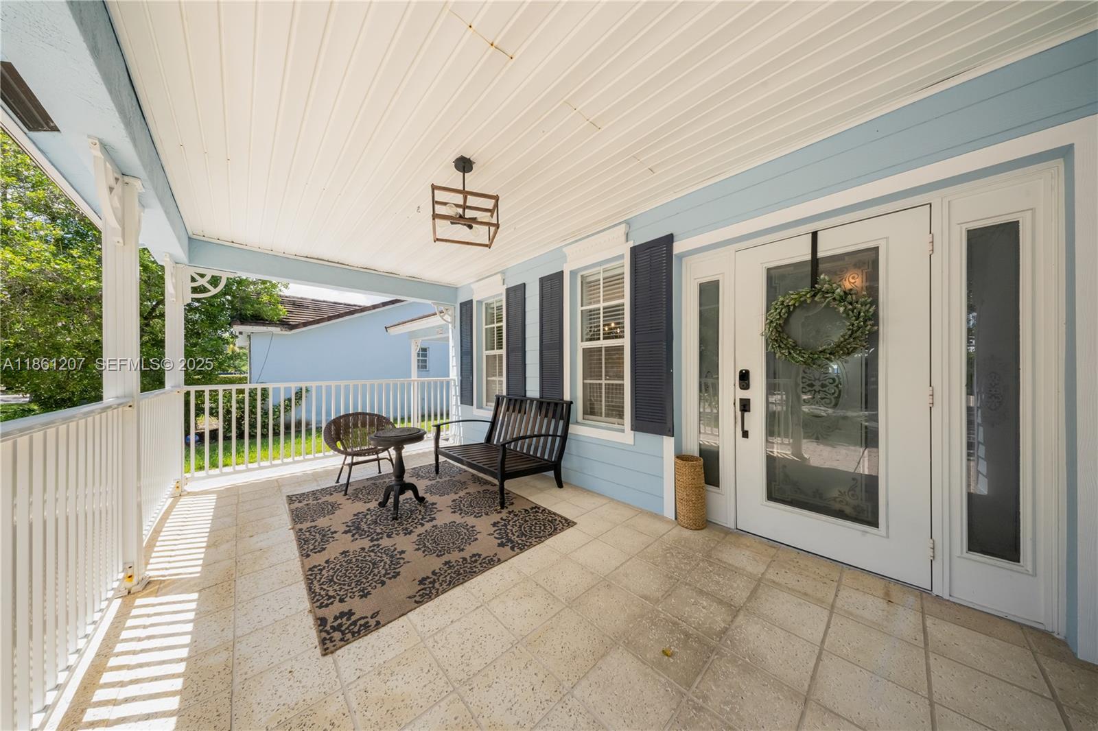 9822 Southwest 161st Place Miami, FL 33196 - Photo 4 of 47 a balcony with furniture and a potted plant