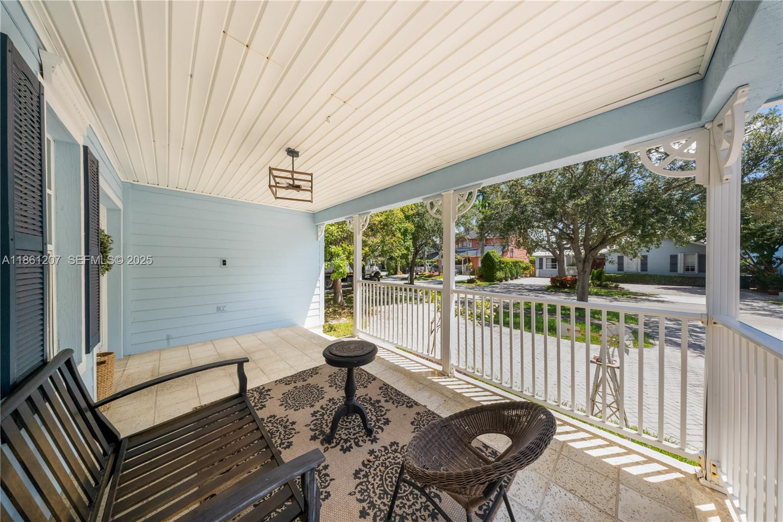 9822 Southwest 161st Place Miami, FL 33196 - Photo 5 of 47 a roof deck with table and chairs and wooden floor