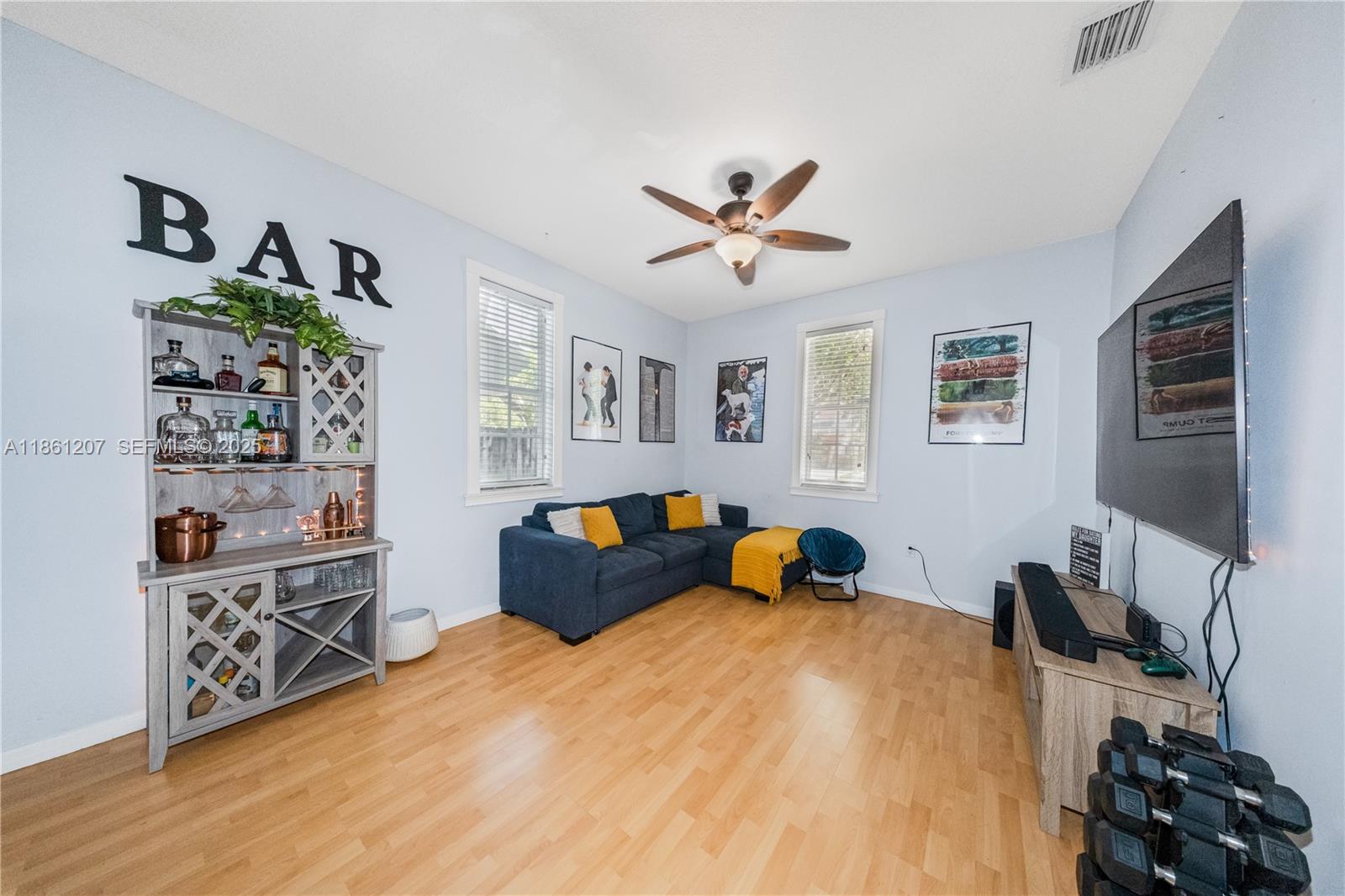 9822 Southwest 161st Place Miami, FL 33196 - Photo 7 of 47 a bedroom with a bed and wooden floor