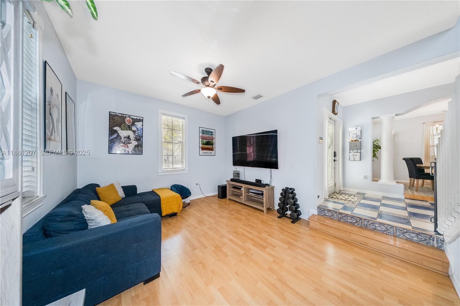 9822 Southwest 161st Place Miami, FL 33196 - Photo 8 of 47 a living room with furniture and a flat screen tv