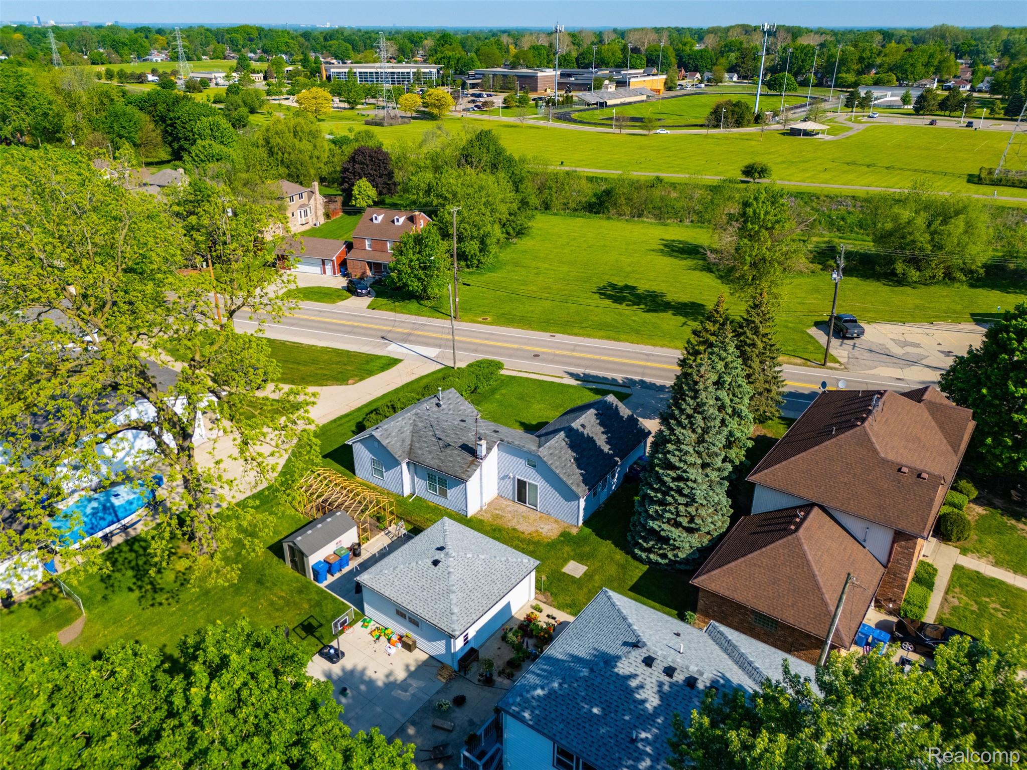 5634 Chicago Road Warren, MI 48092 - Photo 27 of 36 Aerial perspective showcasing a residential property with a brown shingle roof and brick exterior