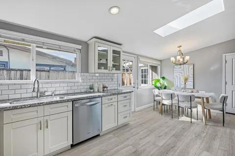 a kitchen with center island table and chairs