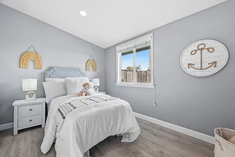 a bedroom with a bed and a window