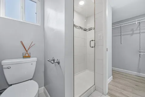 a bathroom with a toilet and a shower