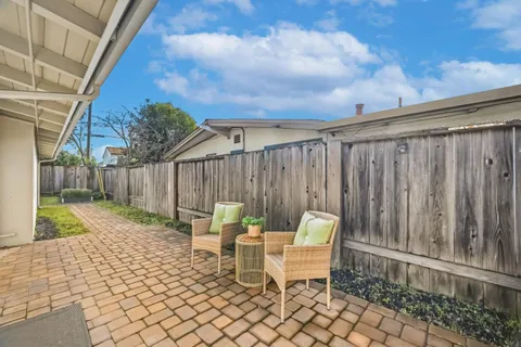 a backyard of a house with table and chairs