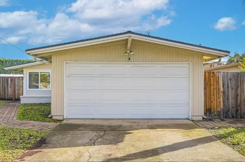 a view of house with backyard space
