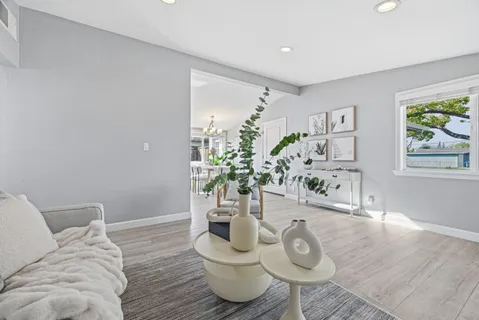 a living room with furniture and wooden floor
