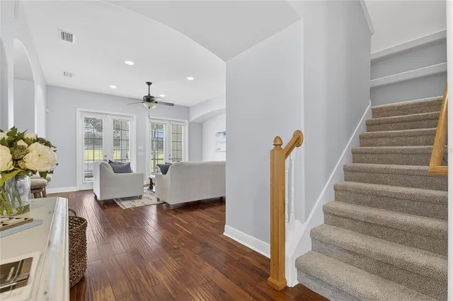 a kitchen with stainless steel appliances granite countertop a sink stove refrigerator and cabinets