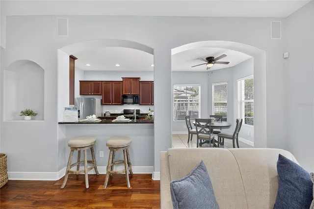 a spacious bedroom with a bed a dresser and a chandelier