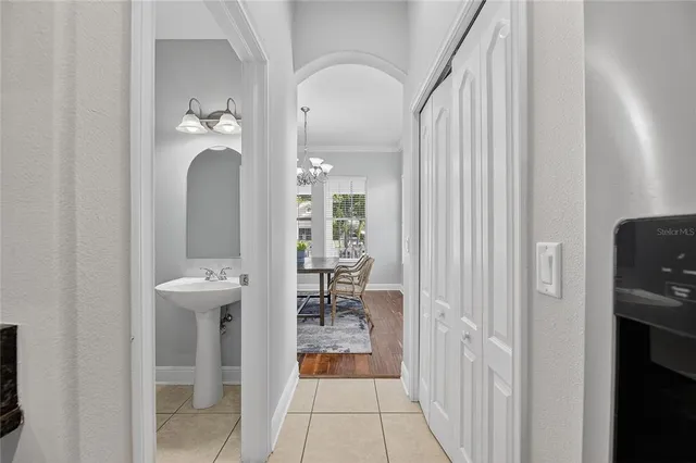 en empty room with windows and chandelier fan