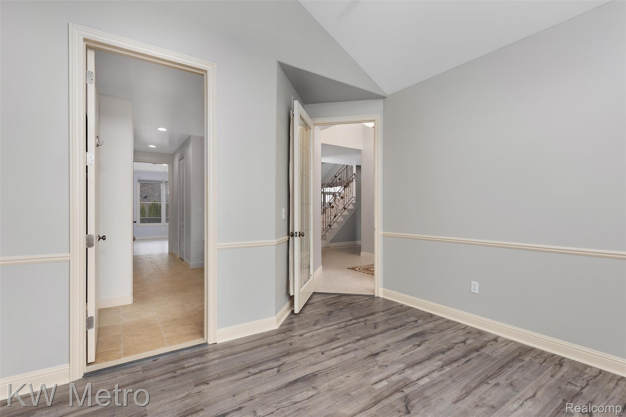 65884 Windrose Court Ray, MI 48096 - Photo 54 of 82 Office connects to primary bathroom featuring light wood-style floors and lofted ceiling