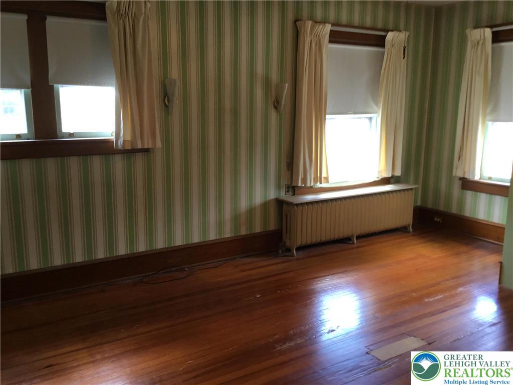 1105 Main Street Slatington, PA 18080 - Photo 19 of 31 Hardwood floors and bright windows illuminate this spacious living area, awaiting your personal touch.
