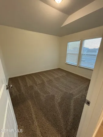 a kitchen with granite countertop a refrigerator and a stove top oven