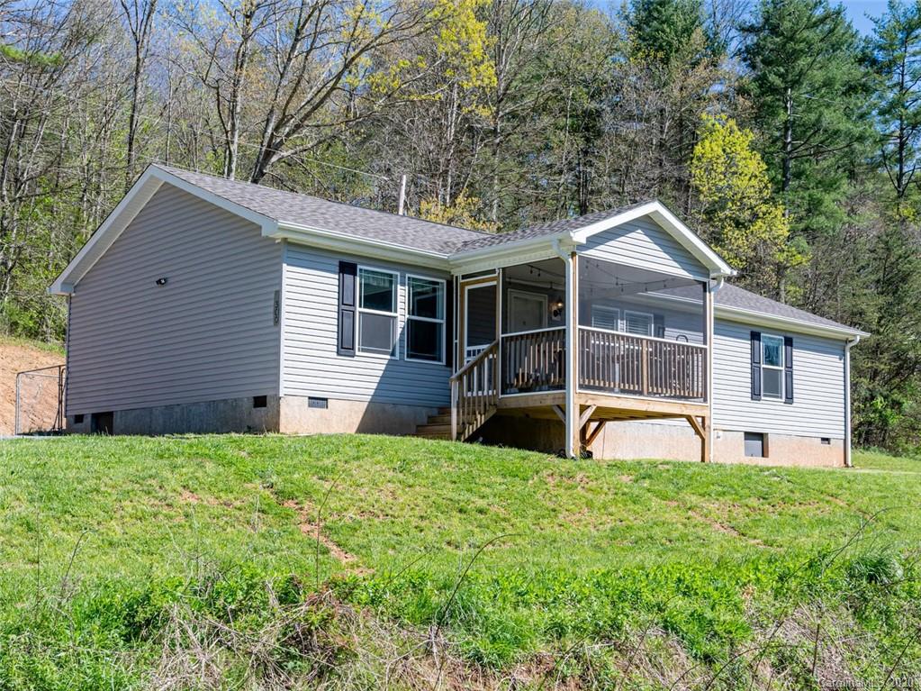 300 Lost Cove Road Clyde, NC 28721 - Photo 1 of 11 a view of a house with a yard and sitting area