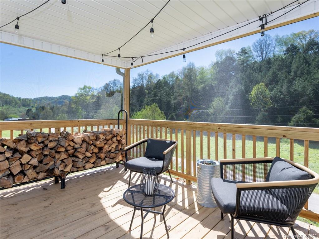 300 Lost Cove Road Clyde, NC 28721 - Photo 2 of 11 a view of a chairs in wooden deck