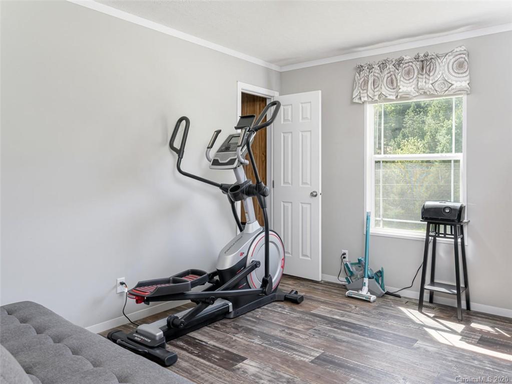 300 Lost Cove Road Clyde, NC 28721 - Photo 8 of 11 a room with gym equipment and windows