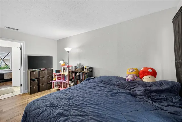 a bedroom with a bed and a flat screen tv